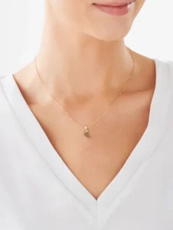 Złota zawieszka z akwamarynem syntetycznym - stópka